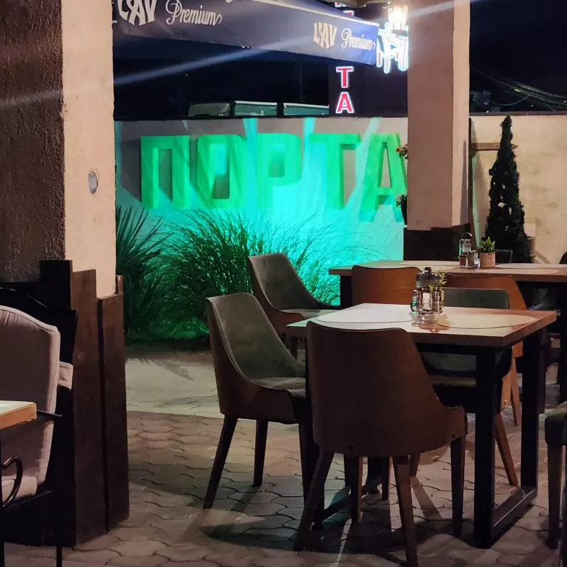 The Porta sign on the terrace wall, lit in green